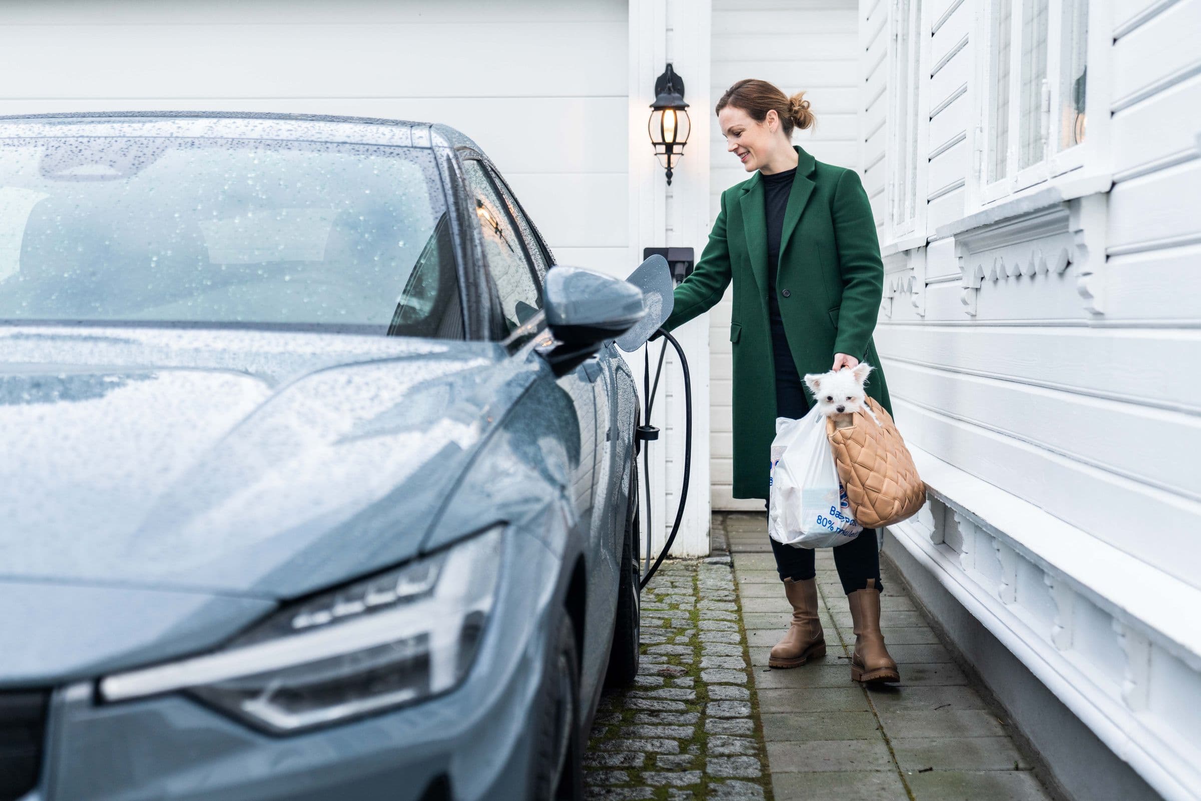 Electric vehicle charging outside a home.